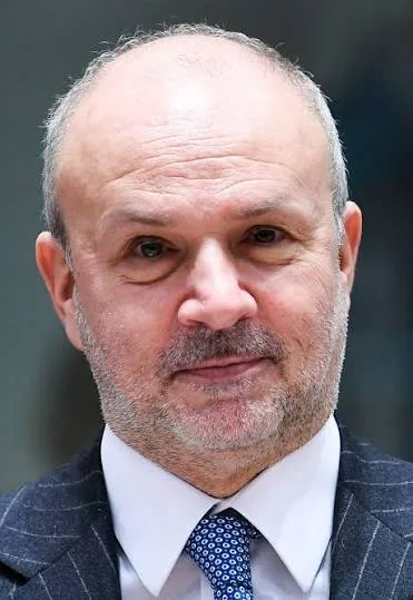 Head-and-shoulders portrait of Orazio Schillaci smiling, in a dark jacket, white shirt and blue patterned tie
